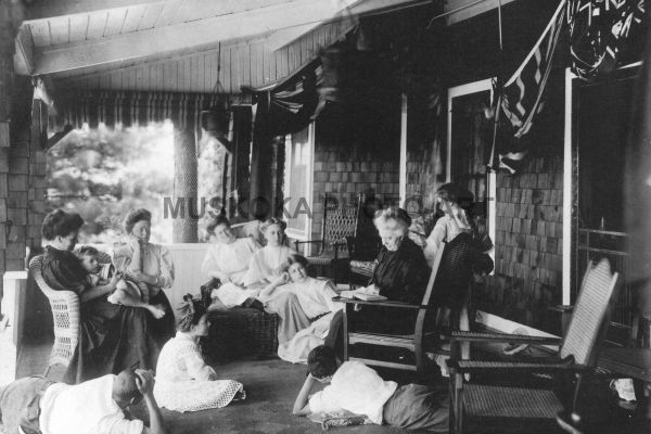 #16 Cottage life, 1905. Grandma reads to family